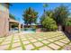 Expansive backyard featuring a pool with lush landscaping, outdoor seating, and meticulous hardscaping at 1204 S Arroya Cir, Mesa, AZ 85206