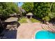 Beautiful backyard featuring an outdoor kitchen, gazebo, and a sparkling swimming pool at 1204 S Arroya Cir, Mesa, AZ 85206
