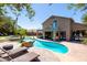 Private backyard oasis featuring a custom pool, spa, outdoor seating areas, and manicured landscaping at 1204 S Arroya Cir, Mesa, AZ 85206