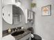 Stylish bathroom featuring a round mirror, modern vanity, and black toilet at 1204 S Arroya Cir, Mesa, AZ 85206