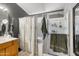 Bright bathroom featuring a shower with glass doors, decorative shower curtain, and well-lit vanity area at 1204 S Arroya Cir, Mesa, AZ 85206