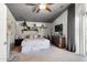 Spacious bedroom featuring a ceiling fan, shelving, and a king size bed at 1204 S Arroya Cir, Mesa, AZ 85206
