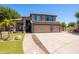 Charming two-story home featuring a three-car garage, desert landscaping, and a paver walkway at 1204 S Arroya Cir, Mesa, AZ 85206