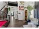 Expansive foyer with staircase, dark hardwood floors, wine rack, and entry to living area at 1204 S Arroya Cir, Mesa, AZ 85206