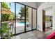 Open game room view featuring outdoor pool access, natural light, and modern styling at 1204 S Arroya Cir, Mesa, AZ 85206
