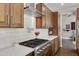 Close-up of the kitchen featuring a stainless steel stove, white subway tile backsplash, and wood cabinetry at 1204 S Arroya Cir, Mesa, AZ 85206