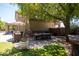 Spacious backyard patio with a large dining table, built-in BBQ, and lush greenery at 1204 S Arroya Cir, Mesa, AZ 85206