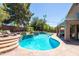 Beautiful pool with stone accents, tanning ledge and lush landscaping provides a tranquil outdoor oasis at 1204 S Arroya Cir, Mesa, AZ 85206