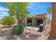 Relaxing covered patio with comfortable seating, landscaping, and outdoor cooking area at 15971 W Indigo Ln, Surprise, AZ 85374