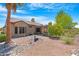 Expansive backyard with desert landscaping and a covered patio, perfect for outdoor living at 15971 W Indigo Ln, Surprise, AZ 85374