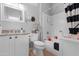 Bright bathroom with granite countertop vanity, updated fixtures, and shower-tub combo at 15971 W Indigo Ln, Surprise, AZ 85374