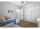 Comfortable bedroom with a blue quilt and access to the ensuite bathroom at 15971 W Indigo Ln, Surprise, AZ 85374
