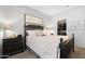 Relaxing bedroom featuring neutral paint, a queen-sized bed, and a well-organized walk-in closet at 15971 W Indigo Ln, Surprise, AZ 85374