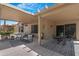 Spacious covered patio features seating areas and a ceiling fan for outdoor entertaining at 15971 W Indigo Ln, Surprise, AZ 85374