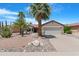 Charming home featuring desert landscaping, palm trees and a two-car garage at 15971 W Indigo Ln, Surprise, AZ 85374