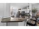 Kitchen with granite countertops and an open floor plan featuring white cabinetry at 15971 W Indigo Ln, Surprise, AZ 85374