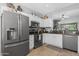 Well-lit kitchen features stainless steel appliances and white cabinetry at 15971 W Indigo Ln, Surprise, AZ 85374