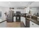 Bright kitchen features stainless steel appliances, white cabinets, and granite countertops at 15971 W Indigo Ln, Surprise, AZ 85374
