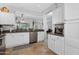 Kitchen showcases white cabinets, stainless steel appliances, and a breakfast bar at 15971 W Indigo Ln, Surprise, AZ 85374