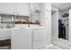 Functional laundry room with washer, dryer, sink, and ample storage at 15971 W Indigo Ln, Surprise, AZ 85374