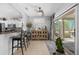 Open concept living space with access to the kitchen and patio at 15971 W Indigo Ln, Surprise, AZ 85374