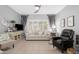 Cozy living room featuring tile floors, neutral walls, and modern decor with bright windows at 15971 W Indigo Ln, Surprise, AZ 85374