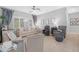 Bright living room with neutral colors, tile flooring, and lots of natural light at 15971 W Indigo Ln, Surprise, AZ 85374