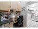Functional home office space with built-in desk, cabinets, and access to additional storage at 15971 W Indigo Ln, Surprise, AZ 85374