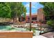 Beautiful water feature with decorative rocks enhancing the tranquil outdoor space and lounge area at 15971 W Indigo Ln, Surprise, AZ 85374