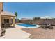 Inviting backyard featuring a sparkling pool, patio seating, and a well-maintained landscape at 16333 W Paradise Ln, Surprise, AZ 85388
