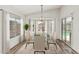 Elegant dining room with a glass table, chandelier, and large windows at 16333 W Paradise Ln, Surprise, AZ 85388