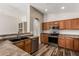 Kitchen featuring stainless steel appliances, wood cabinets, and a breakfast bar area at 16333 W Paradise Ln, Surprise, AZ 85388