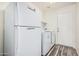 Functional laundry area with appliances and a refrigerator for added convenience at 16333 W Paradise Ln, Surprise, AZ 85388