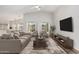 Bright living room featuring vaulted ceilings, neutral furniture, and stylish decor at 16333 W Paradise Ln, Surprise, AZ 85388