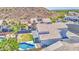 Aerial view showcasing a well-maintained backyard with a pool, lush lawn, and mountain views at 1853 N Rowen Cir, Mesa, AZ 85207