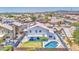 Inviting backyard oasis featuring a covered patio, a sparkling pool, and a well-manicured lawn at 1853 N Rowen Cir, Mesa, AZ 85207