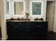 Bathroom with dual sinks, dark cabinetry, and granite countertops at 1853 N Rowen Cir, Mesa, AZ 85207
