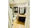 Cozy bathroom featuring a framed mirror, vanity, shower, and decorative wallpaper at 1853 N Rowen Cir, Mesa, AZ 85207