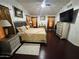 Spacious bedroom with vaulted ceiling, dark wood floors, and comfortable looking furnishings at 1853 N Rowen Cir, Mesa, AZ 85207