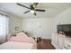 Bedroom with dark wood floors and pink bed, desk, and dresser at 1853 N Rowen Cir, Mesa, AZ 85207