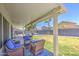 Inviting covered patio featuring comfortable seating and views of the lush, private backyard with a sparkling pool at 1853 N Rowen Cir, Mesa, AZ 85207