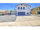 Two story home with a white exterior, desert landscaping, a two car garage and a gray brick driveway at 1853 N Rowen Cir, Mesa, AZ 85207