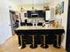 Kitchen featuring dark cabinetry, stainless steel appliances, granite countertops, and seating at 1853 N Rowen Cir, Mesa, AZ 85207