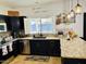 Kitchen featuring dark cabinetry, stainless steel appliances, granite countertops, and natural light at 1853 N Rowen Cir, Mesa, AZ 85207