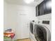 Spacious laundry room equipped with modern, high-efficiency washer and dryer, and plenty of storage at 1853 N Rowen Cir, Mesa, AZ 85207