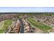 An aerial view showing a street in a suburban neighborhood with golf course at 1881 E Kerby Farms Rd, Chandler, AZ 85249