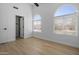 Bedroom featuring hardwood floors, arched windows with blinds, and a closet at 1881 E Kerby Farms Rd, Chandler, AZ 85249