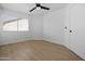Bright bedroom with hardwood floors, ceiling fan, and natural light from a window at 1881 E Kerby Farms Rd, Chandler, AZ 85249