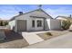 View of side of the home, featuring a two-car garage, bay window, and enclosed patio at 1881 E Kerby Farms Rd, Chandler, AZ 85249