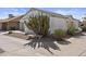 View of the side of the home, showcasing mature landscaping and a bench at 1881 E Kerby Farms Rd, Chandler, AZ 85249